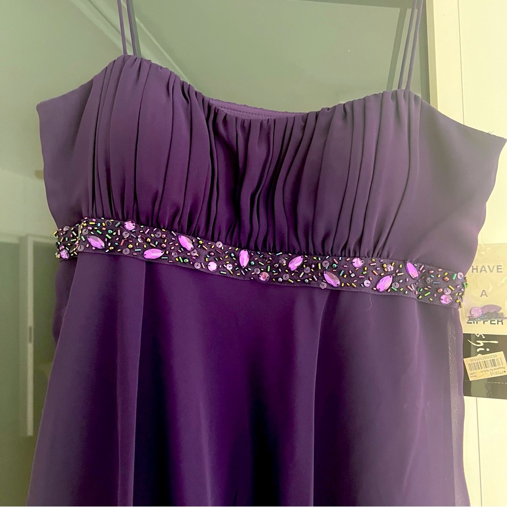 Brand new with tags, purple tiered dress with side zipper and spaghetti straps.